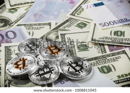 coins of bitcoin on the background of banknotes of dollars and euros. bitcoin the most Popular cryptocurrency in the world