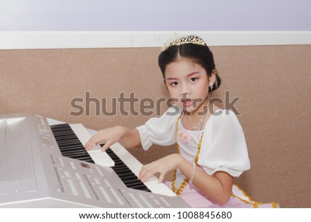 little girl practice electone in music room