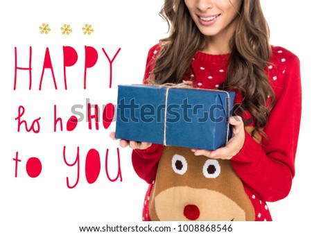 partial view of smiling woman in winter sweater holding christmas gift,  isolated on white, Happy ho ho ho to you lettering