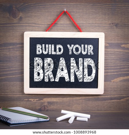 build your brand concept. Chalkboard on a wooden background