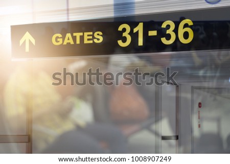 Double exposure of waiting chairs zone in airport or bus station,use as background.,sign at airport with gate arrow and baggage claim for departing flights