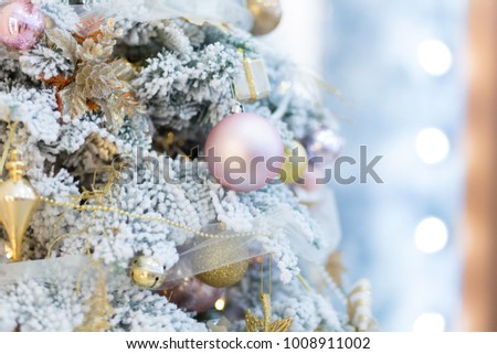 Christmas picture. Bright golden Christmas toys on a Christmas tree. Background of lights garland