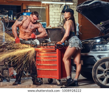 A couple in a garage.