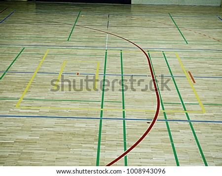 Gym wood floor with playground lines, parquet hardwood in school court. The floor viewed from above for texture pattern 