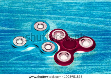 Fidget Spinner in fluorescent UV glowing isolated background for stress release during work