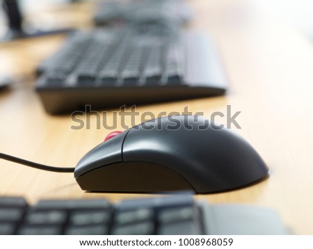 STILL LIFE OF A COMPUTER, MONITOR, MOUSE ON A WOODEN TABLE