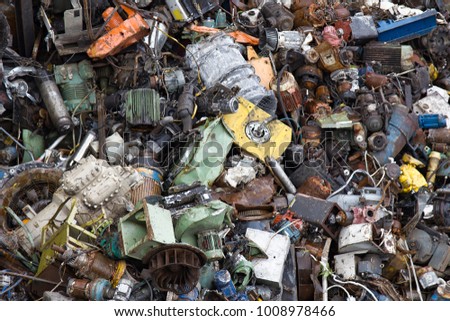Mountain of scrap metal - predominantly ferrous metals. Enterprise for collection of scrap metal. Large number of old motors, engines, electromotors, industrial waste is piled up, metal recycling Royalty-Free Stock Photo #1008978466