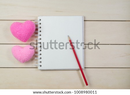 heart shape with notebook on wooden board , love valentine day concept