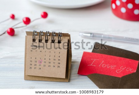 Saint Valentine's Day mark in the calendar on the white background with a note and a pen