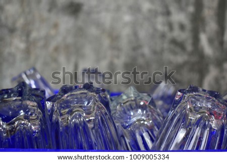 Close-up Glass of water in the basket Backgrounds mortar wall.