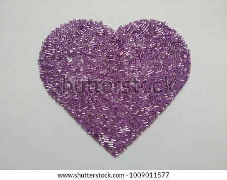 pink glass beads on heart shaped Royalty-Free Stock Photo #1009011577