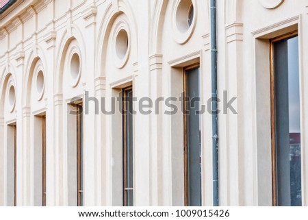 Row of marble columns with windows as classical architectural details with rhythm