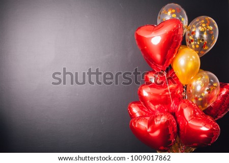 Red heart balloons in a black background, valentines day