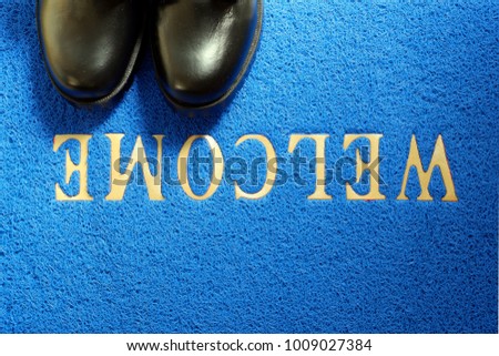 Business man's shoe on blue welcome mat ,top view for copy space