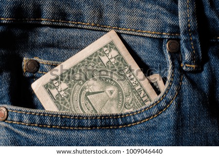 Amarican money Dollar in blue jeans pocket denim background texture.