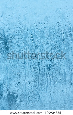 Texture of small water drops on a transparent glass. High humidity and condensation