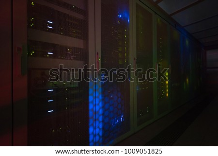 panel modern communication equipment with light from the display at data center in the server room