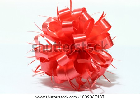 Red sphere new year ribbon on white background. ribbon is a long, narrow strip, used especially for tying something or for decoration.
