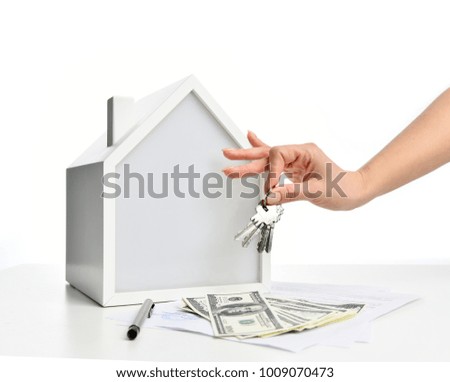 Property Investment concept. Woman hand hold keys from new house symbol of real estate money investment on white background