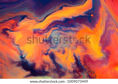 Colorful paint background in concept Fantasy luxury texture. Colors dropped into liquid and photographed while in motion. abstract composition. Royalty-Free Stock Photo #1009073449
