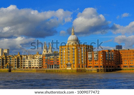 The Thames River with Modern Buildings and St Pauls Cathedral towering over