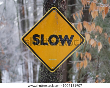 A slow sign on the back roads of New Hampshire during winter
