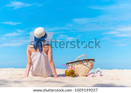 Summer on the beach. Travel background concept, beautiful woman back side sitting on the beach looking to the blue sky. Happy vacation and long weekend. Picture for add text message, design art work.