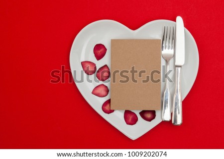 Valentine's dining concept. Heart shaped plate with a blank card