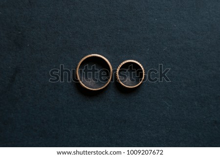 Wedding rings look from above on a black background