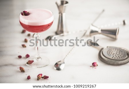 Cocktail in a glass, roses and bar accessories on a white background. Fresh summer drink. Royalty-Free Stock Photo #1009219267
