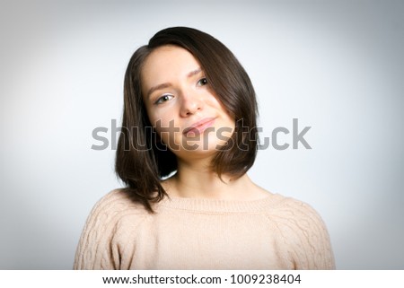 portrait of a tender beautiful young woman in a sweater, isolated on a background, studio photo