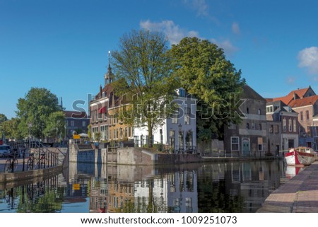 Historic buildings reflected in the water of the Schiedamse Schie in Schiedam Royalty-Free Stock Photo #1009251073