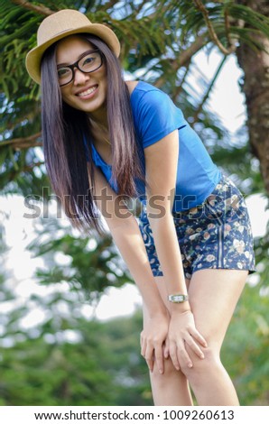 Happy Asians female in cowgirl hat and wear glasses,Standing and looking at camera with toothy smile