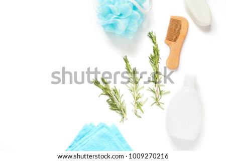 Bathroom mockup, flat lay beauty photo. Natural organic bath products for hair and skin care. Blue sponge, towel, rosemary herb, wooden comb, shampoo white bottle and soap bar
