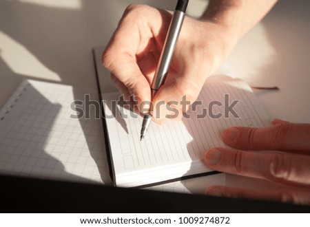 Student holds pen and is ready to write