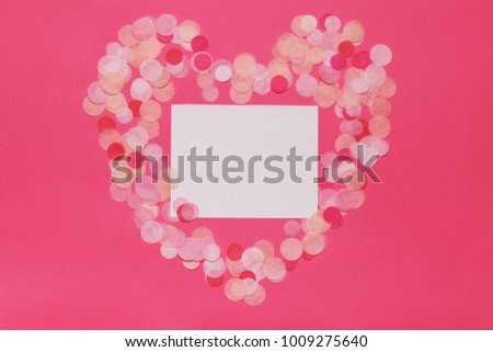 Heart shape made of pink glitter with copy space paper card note. Flat lay. Love concept.