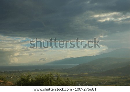 cloudy sky over the mountain and the lake