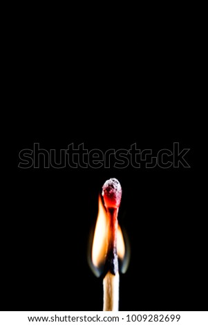 Burning match, on a black background. Macro shot, perfect for a shelf and for further post-production.