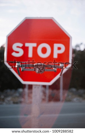 drone flying in front of the stop sign