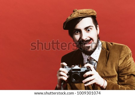 very positive photographer posing in studio with camera