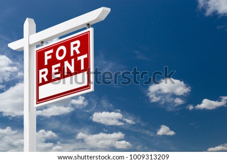 Right Facing For Rent Real Estate Sign Over Blue Sky and Clouds With Room For Your Text.