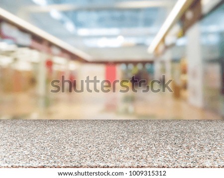 Marble board empty table in front of blurred background. Perspective table over blur in shopping mall - can be used for display or montage your products. Mockup for display of product.