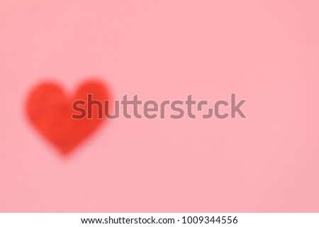 Abstract blur of Paper red heart with Pink Pastel plastic texture background. Valentine concept. Minimal concept. Copy space