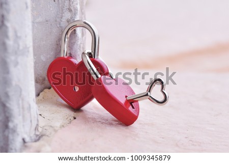 Couple red heart lock with key  lean against vintage pole, valentine love symbol and ending love symbol. Love is an emotion that keeps people bonded and committed to one another. Royalty-Free Stock Photo #1009345879