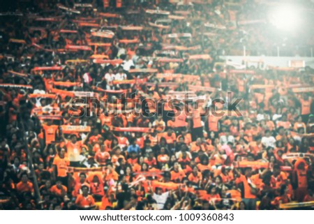 blurry of Soccer fans in a match and Spectators at football stadium