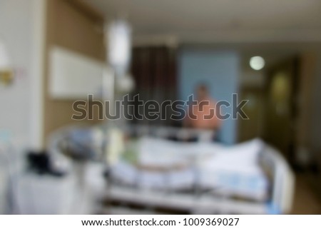 Blurred male patient with saline in arm sitting on bed in the hospital for illness and high fever fine cutout overlay on blur background