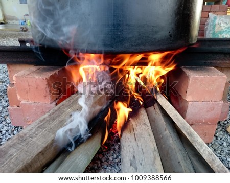 Fire flare from firewood activity to boil a water