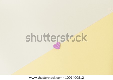 Pink heart with a diagonal on a yellow background.