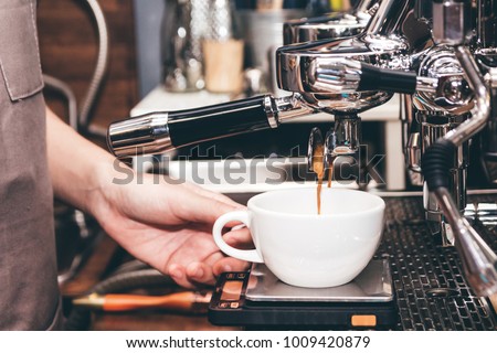Women Barista using coffee machine for making coffee in the cafe Royalty-Free Stock Photo #1009420879