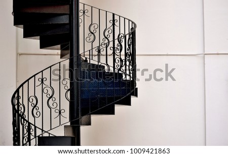 Close up of beautiful wrought iron exterior spiral staircase on the side of a shop house in Singapore with copy space for design
 Royalty-Free Stock Photo #1009421863